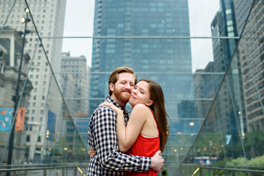 A loving engaged couple smoosh faces during engagement session in dilworth park.